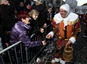 An eldery Gille offers oranges to eldery ladies